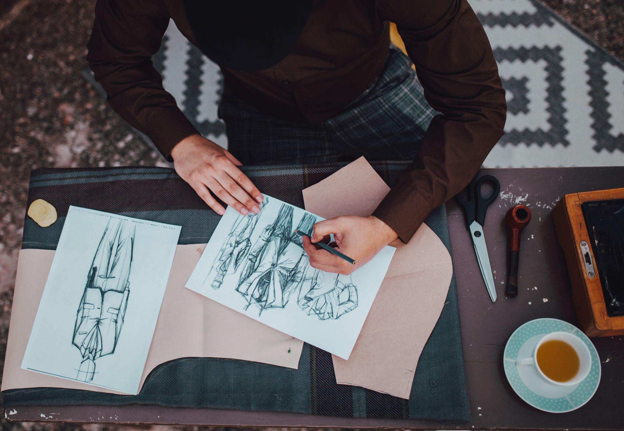 Clothing designers drawing tech pack sketches for a new collection